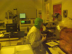 Dima in stanford clean room with microscope
